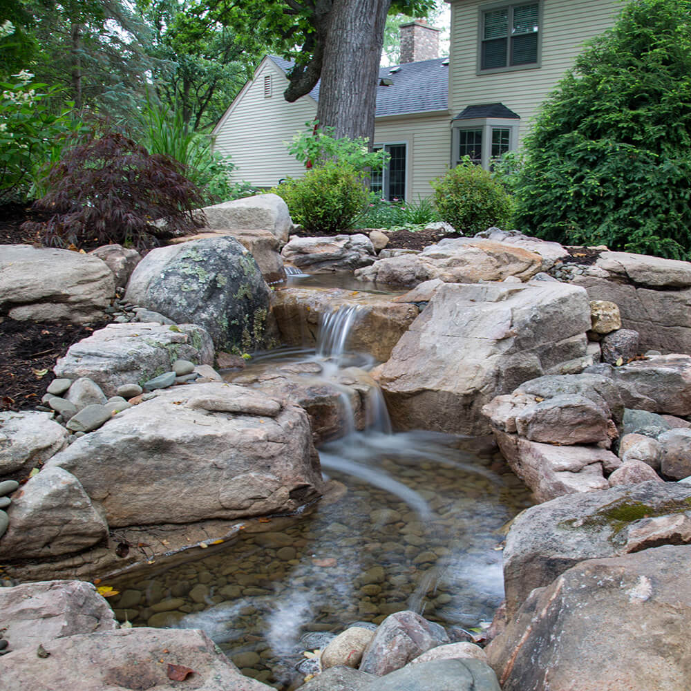 A waterfall with a small pond. 