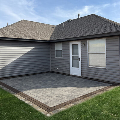 A paver patio designed by White Willow Designs