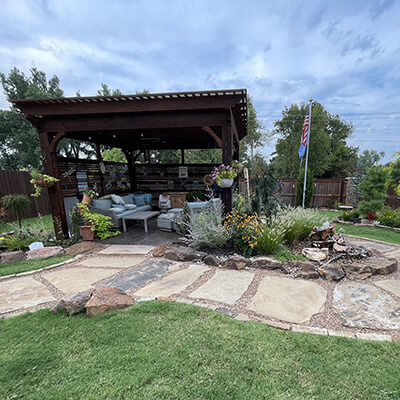 A custom stone walkway around a pergola