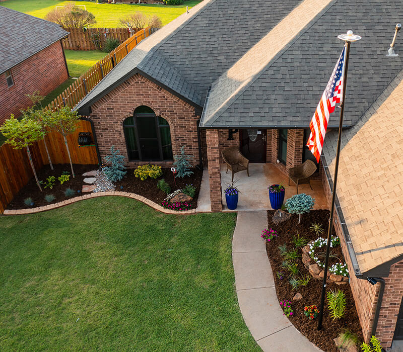 An aerial photo of a home's front yard landscaping