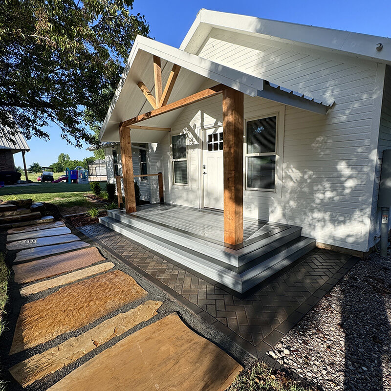 A natural stone walkway by a front porch